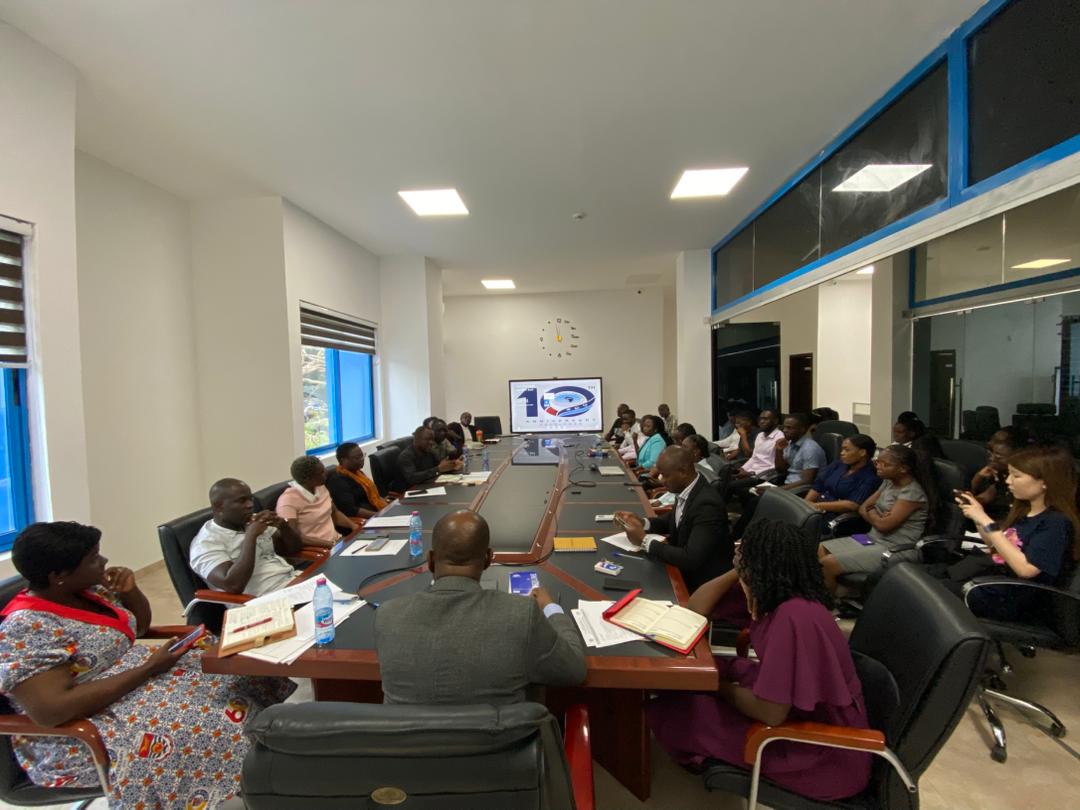 ACECoR-CCM team seated around a long conference table having a discussion about the strategies for the year.